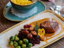 Autumn game platter with meat, chestnuts, Brussels sprouts and red cabbage
