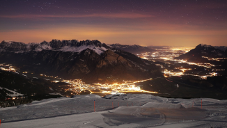 View of the Sarganserland at night View of wintry Sarganserland at night. A ski slope can be seen in the foreground. In the valley you can see the colorful lights.