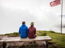 Couple sitting on a bench in the fog