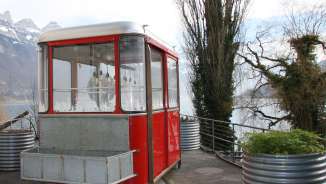 Fondue gondola on Lake Walen A red gondola that has been converted into a fondue restaurant stands on the shore of Lake Walen