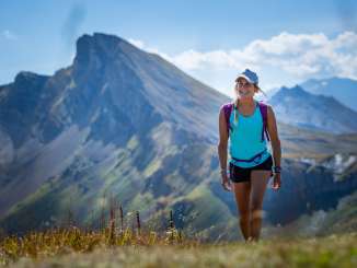Hiking on the 7-summit tour Young woman in summer clothing hikes on the 7-summit tour on the Flumserberg