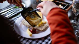 Eating raclette © Kevin Wildhaber