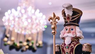 Nutcracker with chandelier in the background